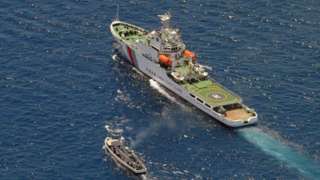 an Asia coast-guard ship (R) and a Philippine offer vessel take part in a stand off once the Philippine motorboat tries to achieve the Second Thomas Shoal, a remote Southern China water a reef reported by both nations, on 29 March 2014