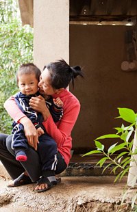 a mother and youngster facing a latrine, Viet Nam.