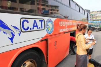 Bus attendant checking passports for appropriate Vietnam visa