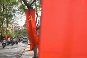 Hammer and sickle on banners along Vietnamese road. The defense of state-owned enterprises happens to be warranted by the alleged socialist-oriented market economy. (Photo: AAP)