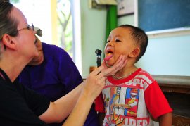 Lt. Cmdr. Laurel Christians, household nursing assistant professional, examines a Vietnamese kid's mouth during a pediatric assessment at a medical civic action system during the Phuoc Hoa secondary college meant for Pacific Partnership 2010.