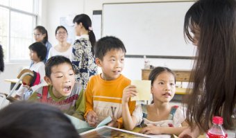 Teaching ESL in a class room with pupils in Asia