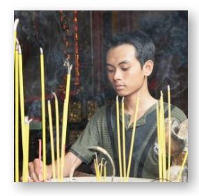 Vietnamese American young man at a traditional altar © Wilfried Krecichwost and Getty graphics