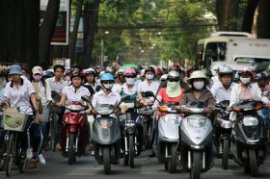 Many motorbike cyclists in Vietnam use masks to guard against dust and air pollution.