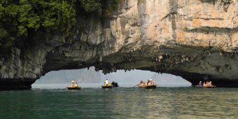 Travelers canoe under a stone arch in Bai Tu longer Bay on April 19, 2015 near Ha longer City, Vietnam. Air NZ begins flying to Ho Chi Minh City from Summer next year. Picture / Getty graphics